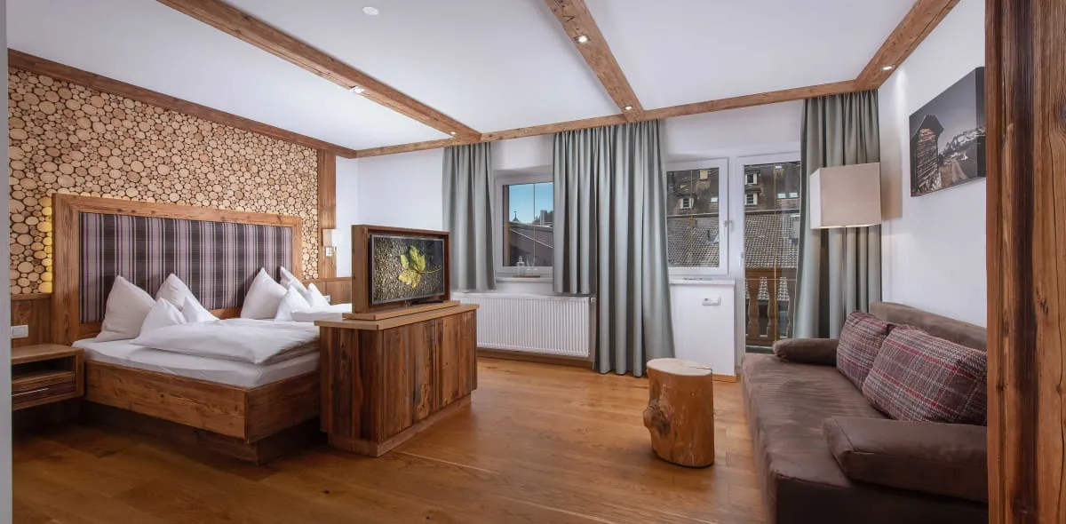 Helles, modernes Schlafzimmer mit Doppelbett und Couch